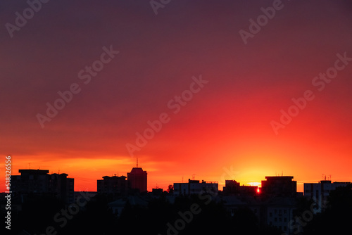 Silhouette of city at sunset. Urban landscape at dawn.