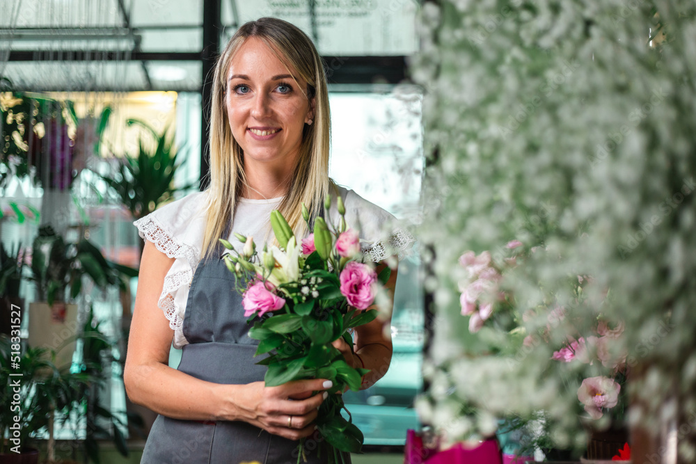 Beautiful girl florist working in flower shop. Making decorations and arrangements. Flowers delivery, creating order. Small business. .