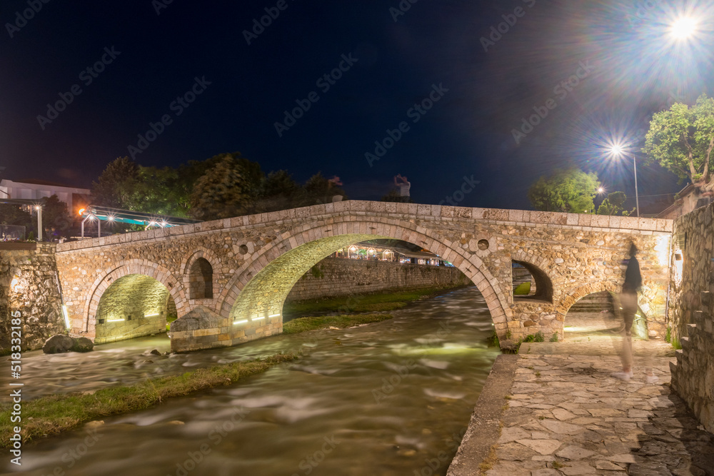 Historic Stone Bridge over Bistrica river at night in Prizren, Kosovo.
