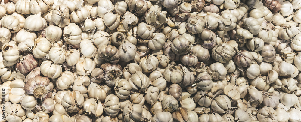 Garlic bulbs top view background. Selective focus. Garlic bulbs top view background. Selective focus.