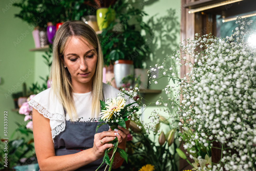 Beautiful girl florist working in flower shop. Making decorations and arrangements. Flowers delivery, creating order. Small business. . Beautiful girl florist working in flower shop. Making decorations and arrangements. Flowers delivery, creating order. Small business. .
