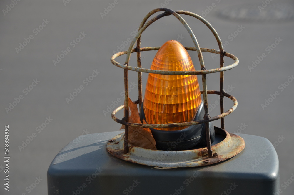 Orange parking lamp in an enlarged view on the street
