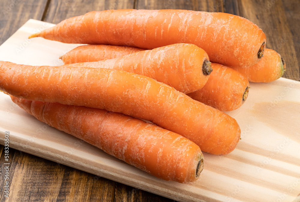 Closeup of carrots over a wooden table Closeup of carrots over a wooden table