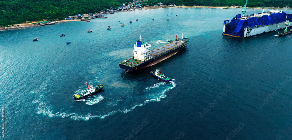 Tug boat drag pull cargo container ship from dry dock concept maintenance service working in the sea. Insurance and Maintenance Cargo Ship concept. Freight Forwarding Service maintenance Insurance