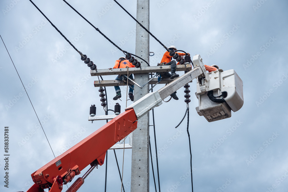 Electricians are climbing on electric poles to install and repair power lines. Electricians are climbing on electric poles to install and repair power lines.