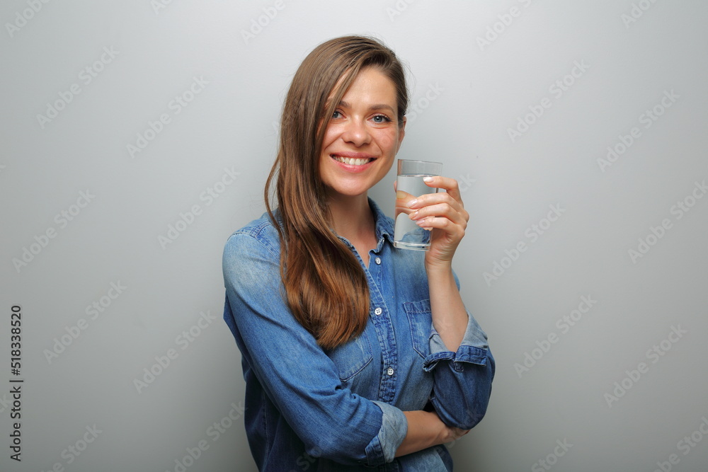 Water glass smiling woman holding near her face. isolated female portrait. Water glass smiling woman holding near her face. isolated female portrait.