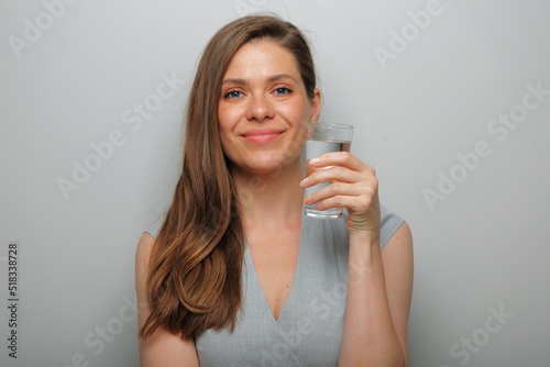 Smiling woman holding water glass isolated female portrait.