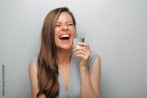 Emotional laughing woman holding water glass isolated female portrait.