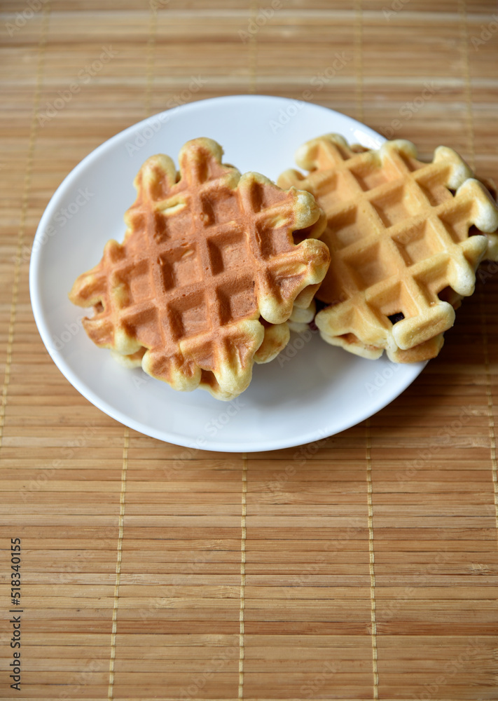 Golden delicious viennese waffles wooden. Wooden background. Raspberry isolated. Gourmet food. Golden delicious viennese waffles wooden. Wooden background. Raspberry isolated. Gourmet food.