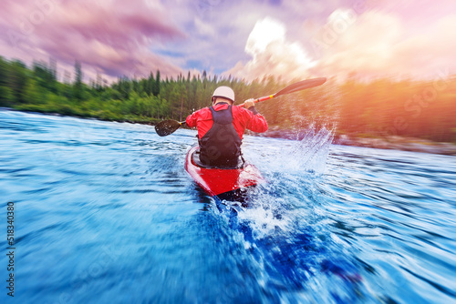 Sport Man is kayaking with spray paddle splashes. Summer day  travel concept