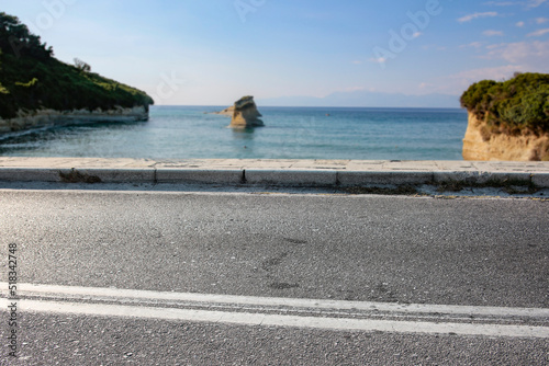 Asphalt road and sea and sky background