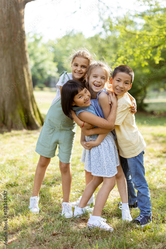 Group of asian and caucasian kids having fun in the park