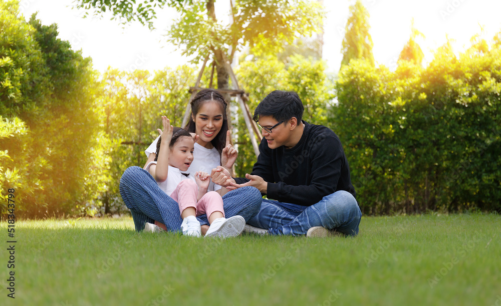 Asian family A cute and bright daughter is resting by running in the field. Asian family A cute and bright daughter is resting by running in the field.