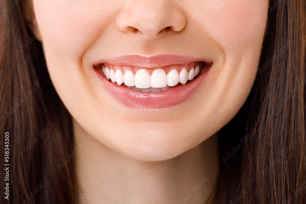 A beautiful woman is smiling. a smile with white teeth. Close up image. A beautiful woman is smiling. a smile with white teeth. Close up image.