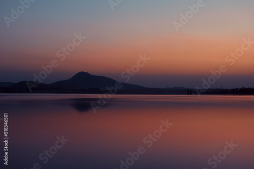 Dramatic hued skyline of Barhanti  Baranti  Hill and adjoining Baranti lake just after sunset. The lake is a man-made water reservoir. It is a popular travel destination in Purulia district of Bengal.