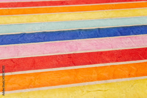 background of colored or multicolored stripes in perspective, in recycled material. Fiber textured paper.