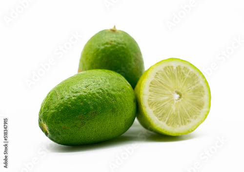 fresh whole and slice green Lemons isolated on white background