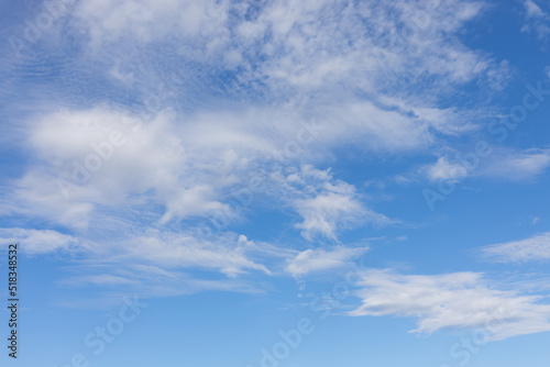 Blue sky with light weightless white clouds. Airy skyscape background © Вера Тихонова
