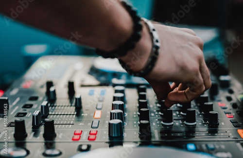 DJ Hands creating and regulating music on dj console mixer in concert outdoor