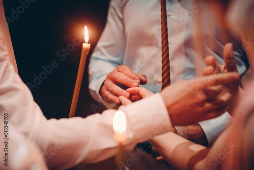 bride and groom holding rings