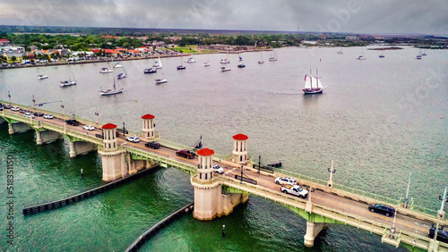 Bridge of Lions with a view of the harbor and a sail boat. 