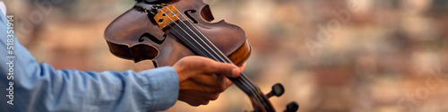 Linkedin banner with an inspired musician holding a violin in his hand