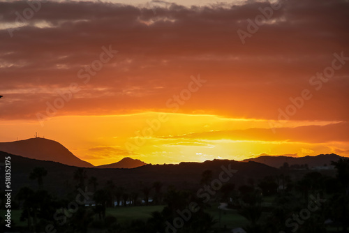 Beautiful colorful sunset sky with silhouette of hills and mountain landscape near Golf del Sur  Tenerife  Canary Islands  Spain  Europe  EU. Vacation vibes on touristic island in Atlantic Ocean