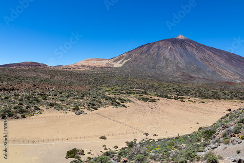 La Canada de los Guancheros dry desert plain with scenic view on volcano Pico del Teide, Mount El Teide National Park, Tenerife, Canary Islands, Spain, Europe. Hiking trail to Riscos de la Fortaleza