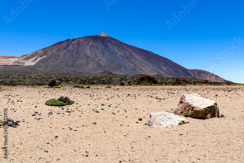 La Canada de los Guancheros dry desert plain with scenic view on volcano Pico del Teide, Mount El Teide National Park, Tenerife, Canary Islands, Spain, Europe. Hiking trail to Riscos de la Fortaleza photo