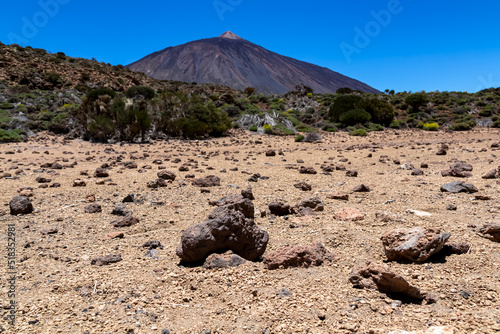 Pumice stones on desert plain La Canada de los Guancheros. Scenic view on volcano Pico del Teide, Mount El Teide National Park, Tenerife, Canary Islands, Spain, Europe. Hike to Riscos de la Fortaleza photo