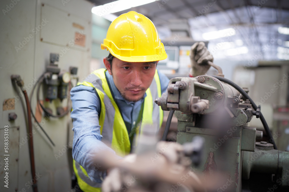 Portrait of a Professional Heavy Industry Engineer Worker Wearing Uniform, Glasses and Hard Hat in a Steel Factory. Industrial Specialist Standing in Metal Construction Facility. Portrait of a Professional Heavy Industry Engineer Worker Wearing Uniform, Glasses and Hard Hat in a Steel Factory. Industrial Specialist Standing in Metal Construction Facility.
