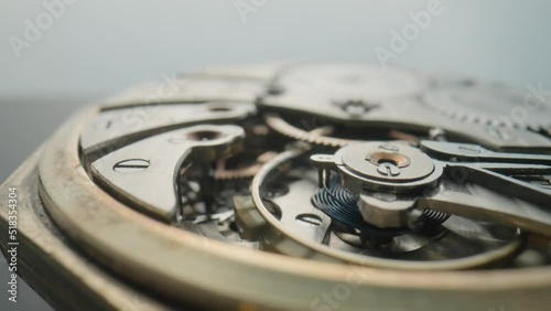 Wallpaper Mural Macro shot of the internal parts of antique pocket watch on a light gray studio background. Clockwork with rotating spring, gears, cogwheel and tootheds wheels. Disassembled silver retro watch inside. Torontodigital.ca