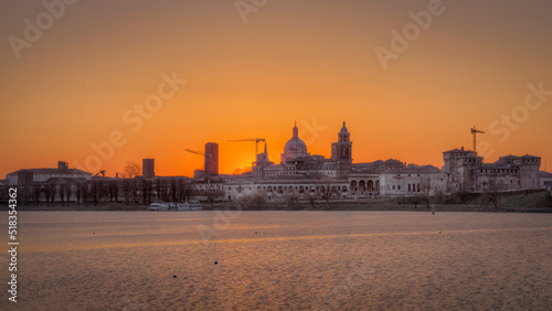 View of Mantua historic center from the upper lake. Sunset February 2022, visible the basilica, the Gonzaga castle and the bridge that connects the city on the north side. You can see the many medieva photo