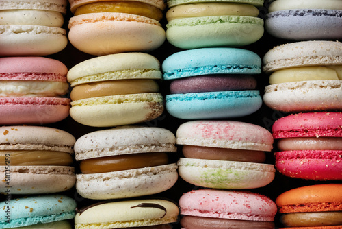 Colorful macaroons, macro shot, filling from different flavors is visible.