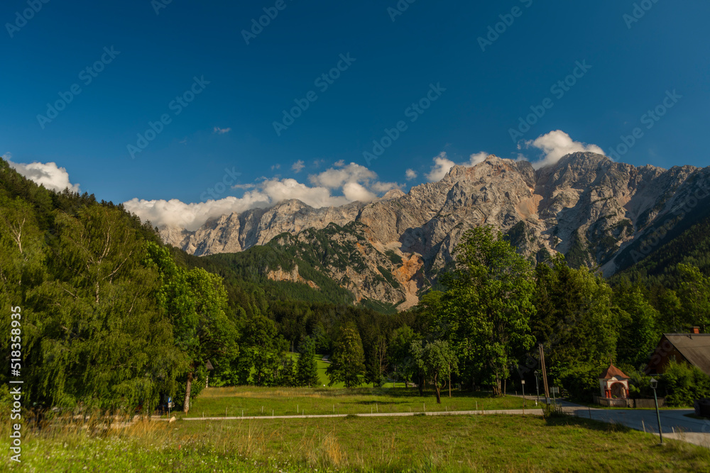Big rock stone hills over Bovec village in Slovenia mountains near Soca river
