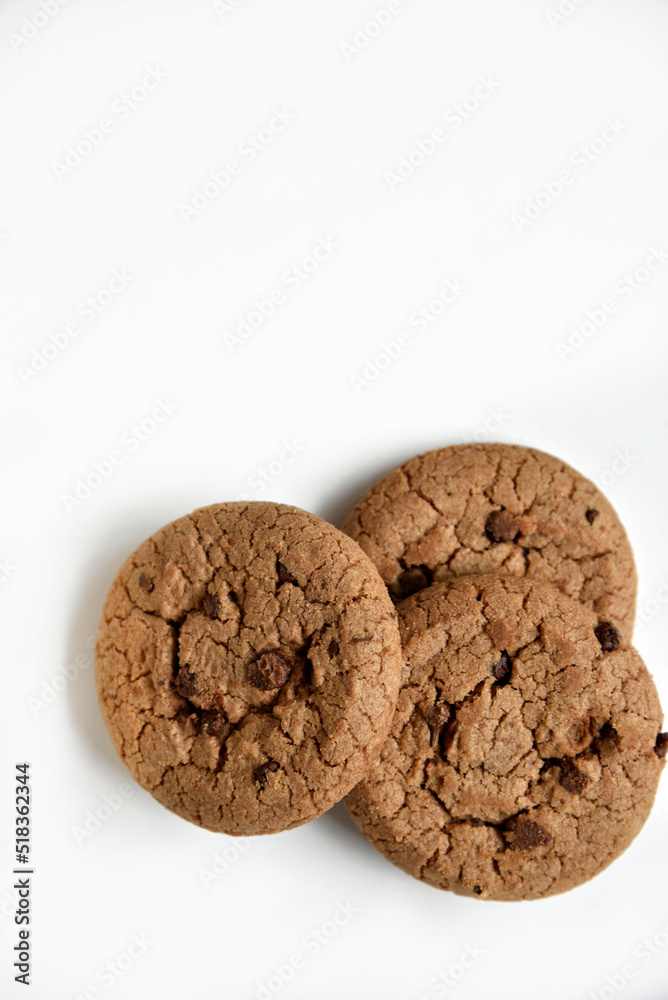 Oatmeal cookies with chocolate chips on a white background. Cookies are delicious close-up. Oatmeal cookies with chocolate chips on a white background. Cookies are delicious close-up.