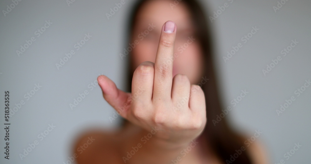 Obraz premium Angry young woman giving the middle finger to camera