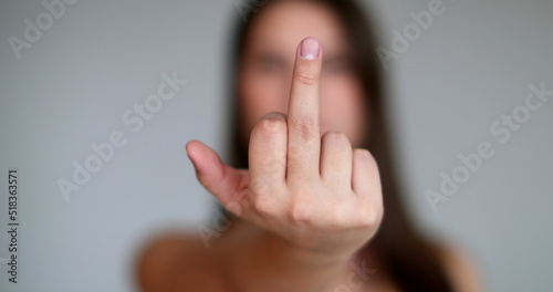 Angry young woman giving the middle finger to camera