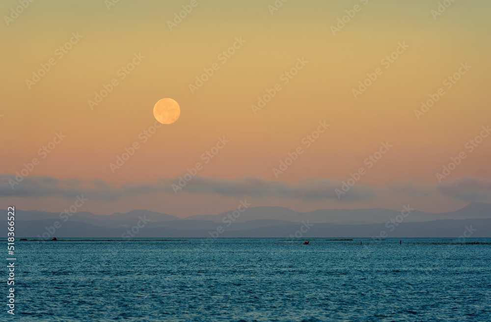 Salish Sea Georgia Strait Moonset. Moonset over the Salish Sea Strait of Georgia. Vancouver Island lies on the horizon.

