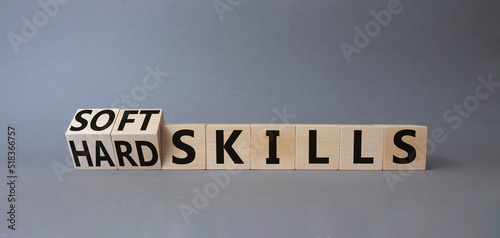 Soft Skills and Hard Skills symbol. Turned cubes with words Soft Skills and Hard Skills. Beautiful grey background. Businessman hand. Business concept. Copy space