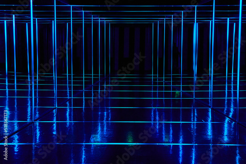 Mirror walkway lined with blue neon lights photo