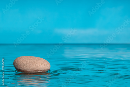 Zen background blue color with stones for spa, meditation and relaxation. Copy space for text.