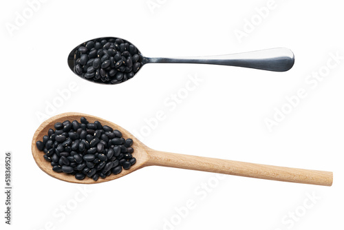 wooden and metal spoon with black beans isolated on white background top view.