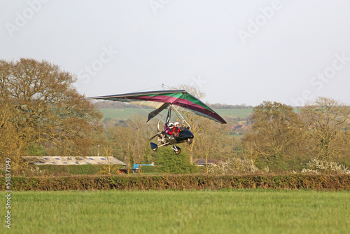 Ultralight airplane taking off from a farm strip	 photo