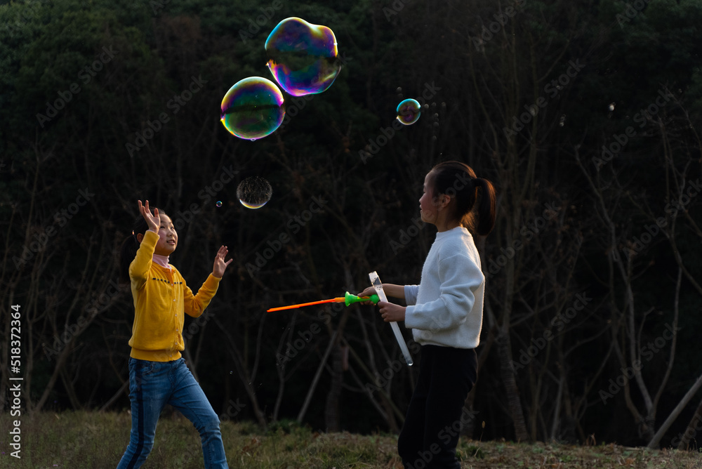 Two kids playing soap bubble outdoor Stock Photo | Adobe Stock