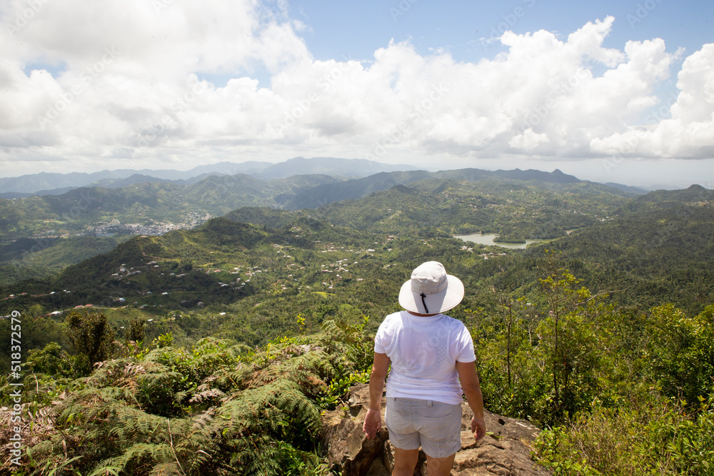 Naklejka premium Woman Hiking Mountain Top in Puerto Rico. Great View from Mountain Peak. Outdoor Travel Adventure.