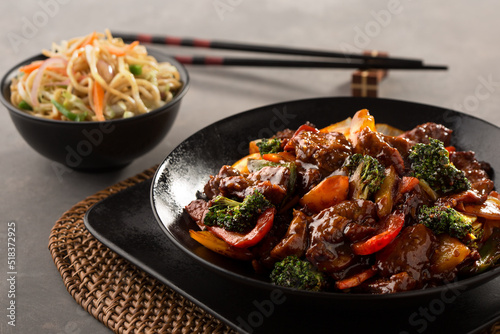 Fotografie beef with broccoli and stir-fry noodles served in dish isolated on dark backgrou