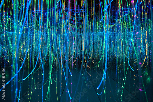 Mirror hallway filled with glowing strings photo