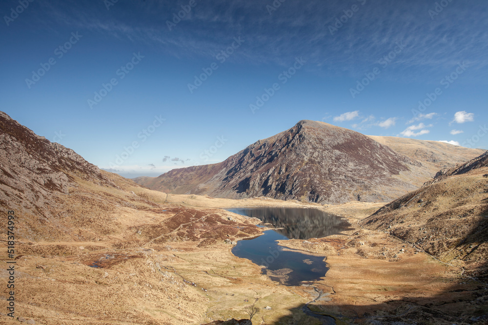 A wide angle view from atop Y Garn, Snowdonia showing the Carneddau, Tryfan and the Glyders mountain range. Ridges and trails lead down to the Ogwen Valley.
