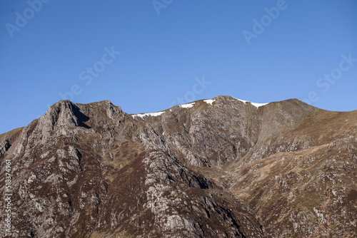 mountain peak at a mountain ridge under a clear blue sky